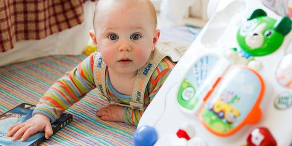 toddler playing safely in outdoor playpen